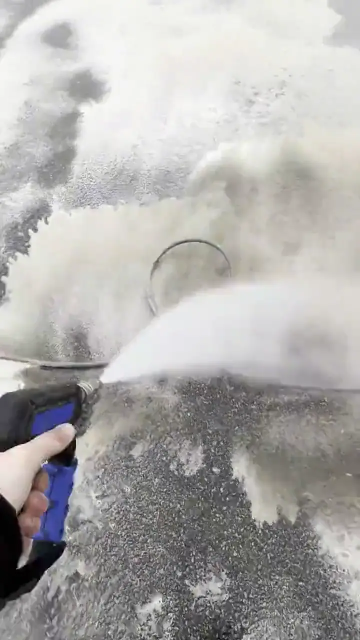 A surface cleaner leaving a clean arc across a concrete driveway — The Total Wash Co., Madison WI
